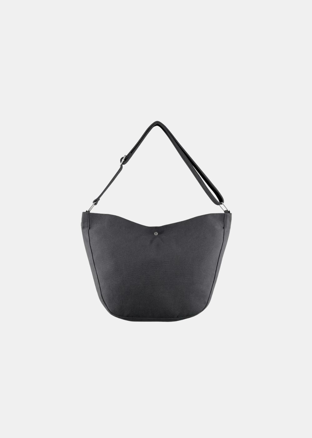 Vue arrière épurée du sac besace A.P.C. noir. Montre la structure uniforme en toile de coton solide, les coutures renforcées ainsi que la bandoulière ajustable fixée par des anneaux métalliques