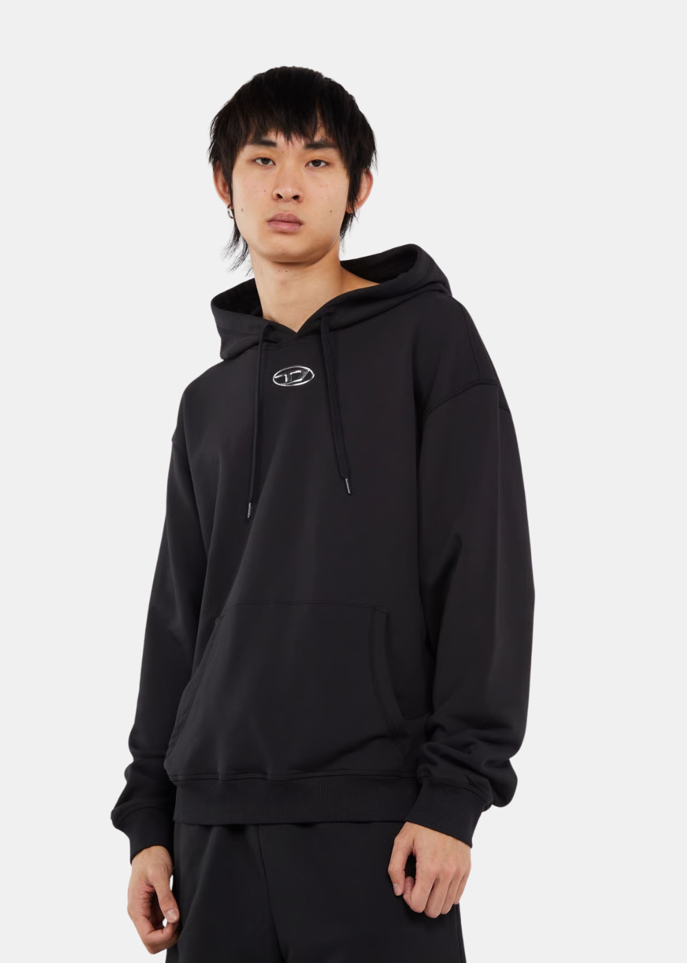 Sweat à capuche Diesel S-NORM noir pour homme porté de face avec logo métal ovale sur la poitrine.