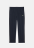 Pantalon de survêtement Lacoste bleu marine avec plis marqués et logo crocodile, vue de face.