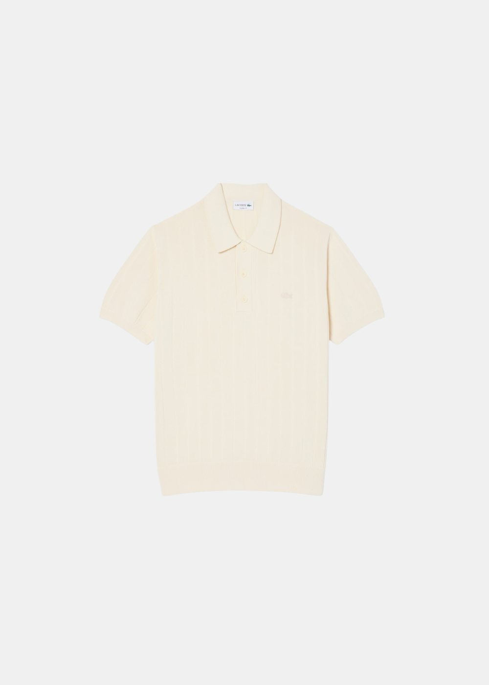 Polo Lacoste en maille côtelée beige fluide avec col classique et logo crocodile, vue de face.