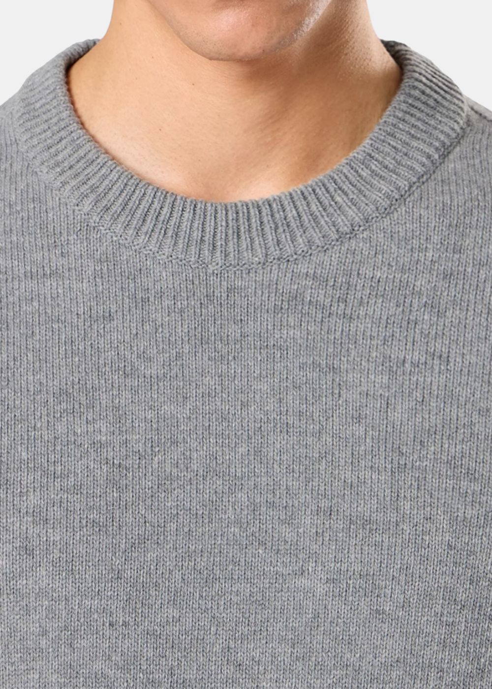 Gros plan sur le col rond tricoté en côtes d'un pull en laine de agneau gris chiné Stone Island.