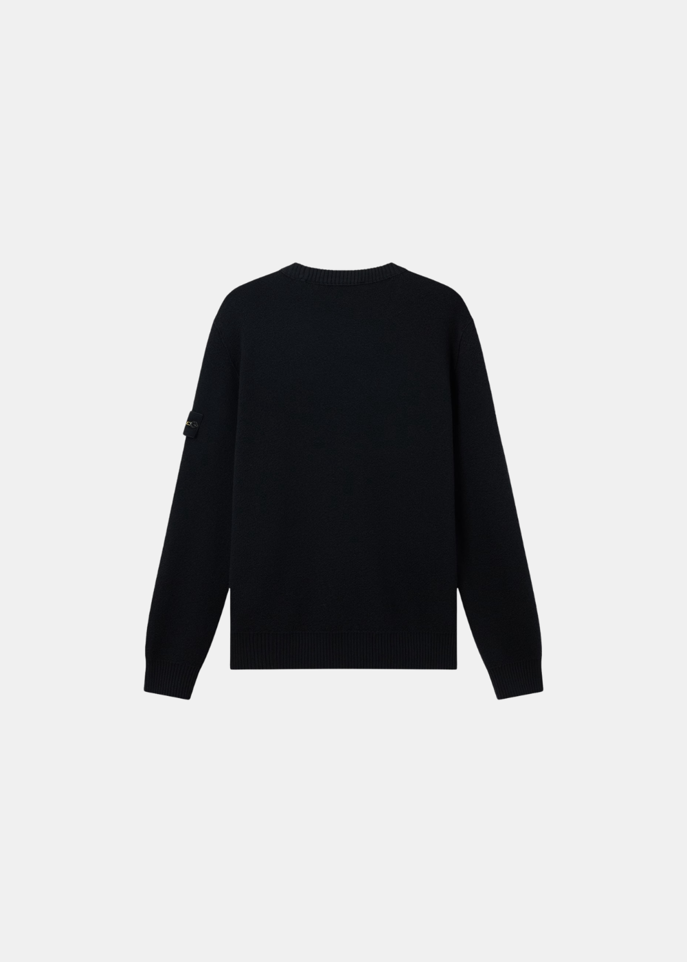 Pull noir en pure laine posé à plat, vue de dos épurée