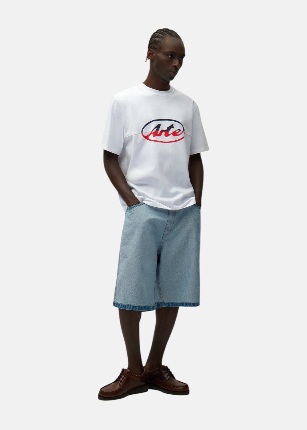 Silhouette complète avec short inversé bleu clair Arte Antwerp et t-shirt blanc, style streetwear.
