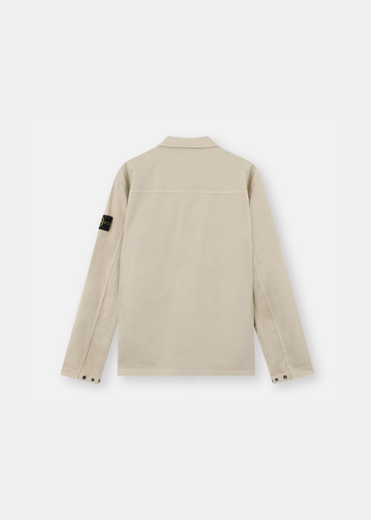 Packshot de dos d'une surchemise beige Stone Island montrant la coupe droite, l'empiècement horizontal et les finitions unies.