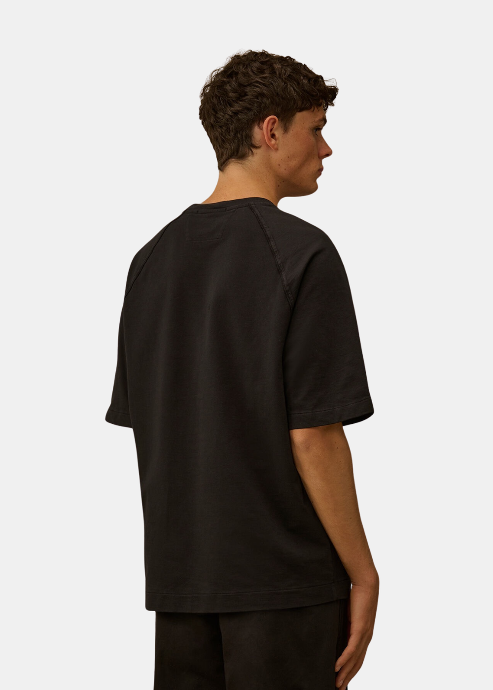 Mannequin homme vu de dos portant le t-shirt C.P. Company noir, montrant les coutures raglan et la structure épurée du vêtement