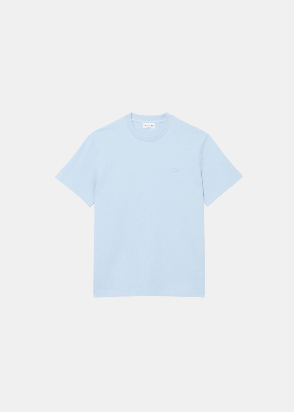 T-shirt Lacoste en jersey de coton bleu ciel avec logo crocodile ton sur ton, vue de face sur fond clair.