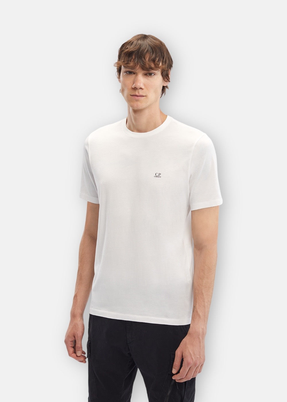 Homme portant le T-shirt C.P. Company blanc, vue de face.