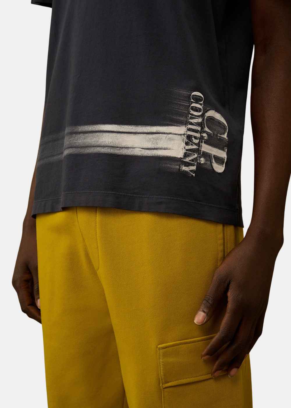 Zoom sur l'imprimé graphique blanc effet peint à la main avec logo C.P. Company sur le bas du t-shirt.