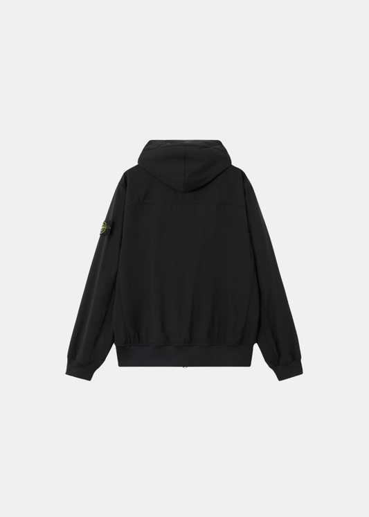 Vue de dos de la veste technique Stone Island noire montrant la structure de la capuche.