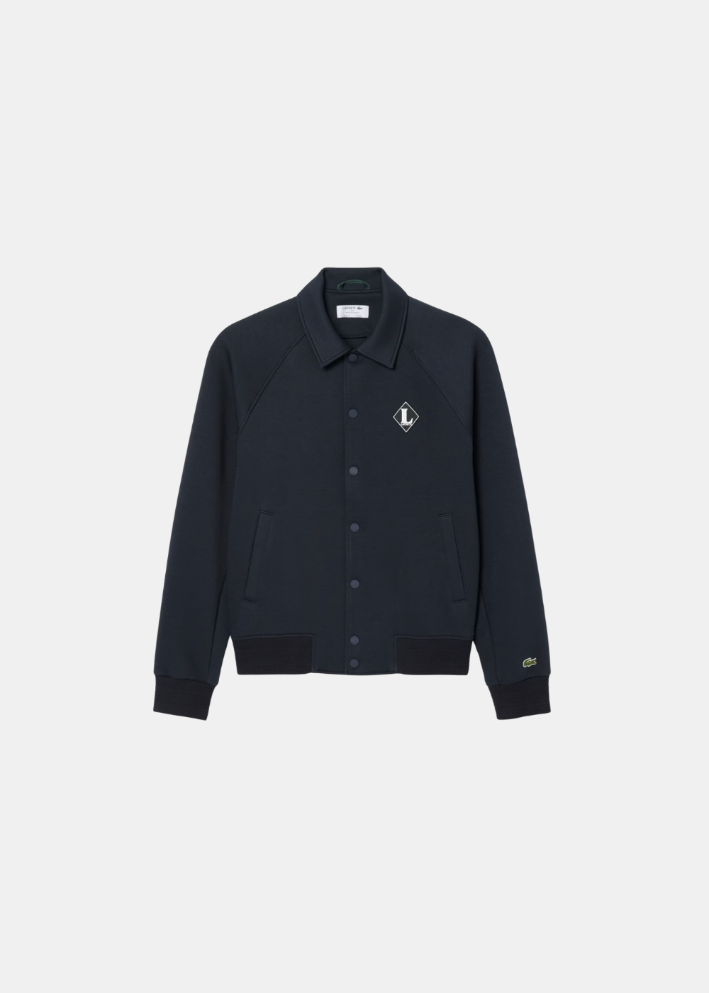 Veste teddy Lacoste marine à manches raglan, boutons-pression et badge rétro, vue de face.